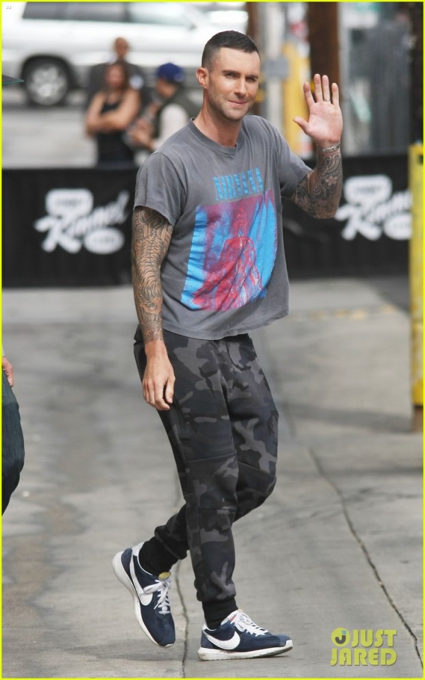 Adam Levine is all smiles as he waves to fans wearing a Nirvana shirt with grey camouflage sweat pants with blue nikes as he arrives for Jimmy Kimmel show in Hollywood, CA