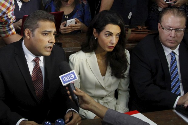 Al-Jazeera-television-journalists-Mohamed-Fahmy-C-and-Baher-Mohamed-L-talk-to-the-media-with-lawyer-Amal-Clooney