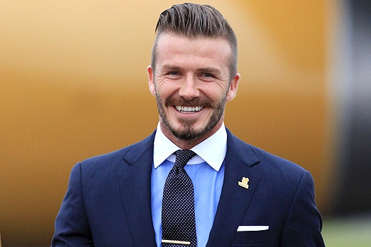 HELSTON, ENGLAND - MAY 18:  David Beckham holds the Olympic Flame as it arrives at RNAS Culdrose near Helston on May 18, 2012 in Cornwall, England. The Olympic Flame arrived in the UK after it was handed over at a ceremony yesterday in Athens. A British delegation including David Beckham, flew back with the flame from Greece where they attended a ceremony welcoming the flame, before it is taken on a 70-day relay involving 8,000 torchbearers covering 8,000 miles.  (Photo by Matt Cardy/Getty Images) 
