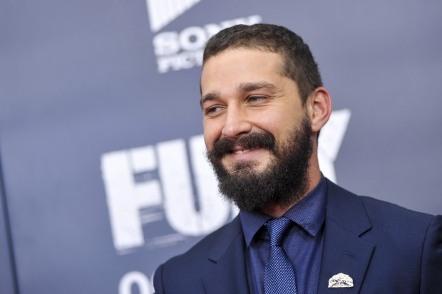 WASHINGTON, DC - OCTOBER 15: Shia LaBeouf poses for photographers on the red carpet during the "The Fury" Washington D.C. premiere at The Newseum on October 15, 2014 in Washington, DC. (Photo by Kris Connor/Getty Images) 