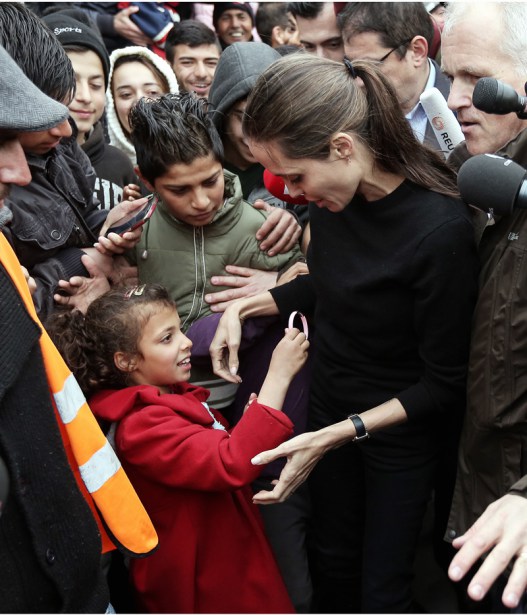 Hollywood actress Angelina Jolie has visited Pireaus port where there is a migrants' camp, near Athens, Greece Pictured: Angelina Jolie is given a bracelet as a gift a a migrant girl Ref: SPL1247154  160316   Picture by: K Baltas/Intime/Athena/Splash Splash News and Pictures Los Angeles:	310-821-2666 New York:	212-619-2666 London:	870-934-2666 photodesk@splashnews.com 