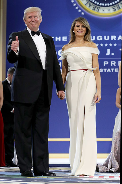 WASHINGTON, DC - JANUARY 20:  U.S. President Donald Trump (L) and first lady Melania Trump thank guests during the inaugural Armed Forces Ball at the National Building Museum January 20, 2017 in Washington, DC. The ball is part of the celebrations following Trump's inauguration.  (Photo by Chip Somodevilla/Getty Images) 