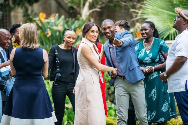 Meghan, Duchess of Sussex(C) arrives at the British High Commissioner residency in Johannesburg where she  will meet with Graca Machel, widow of former South African president Nelson Mandela, in Johannesburg, on October 2, 2019. - Prince Harry recalled the hounding of his late mother Diana to denounce media treatment of his wife Meghan Markle, as the couple launched legal action against a British tabloid for invasion of privacy. (Photo by Michele Spatari / AFP) (Photo by MICHELE SPATARI/AFP via Getty Images) 