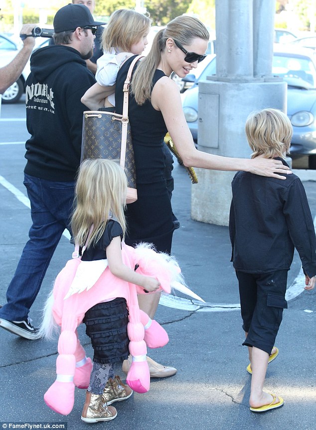Tender: Angelina tenderly placed her hand on daughter Shiloh's shoulder as they made their way back to the car