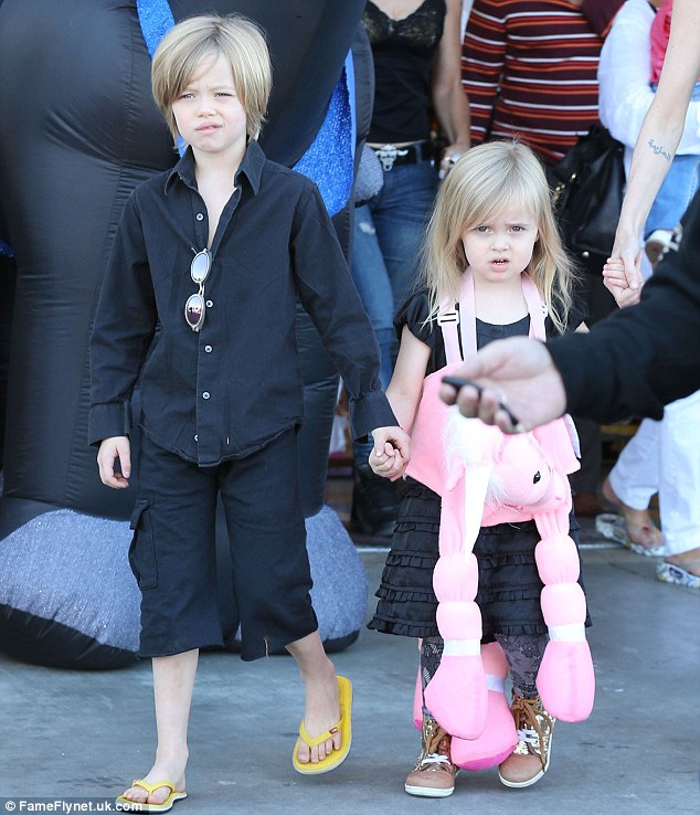 Adorable: Shiloh held her little sister's hand as they exited the store