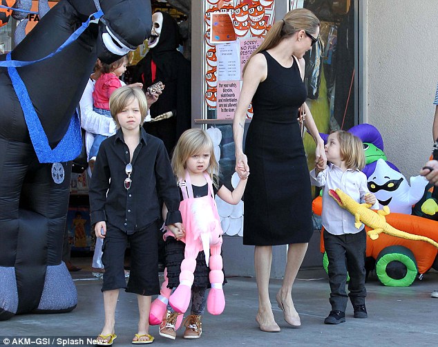 Doting: Angelina doted over her beautiful children during the sunny day out