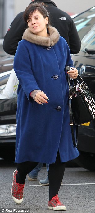 All wrapped up: Lily Cooper covered up her baby bum with a large navy coat as she ran errands earlier today 