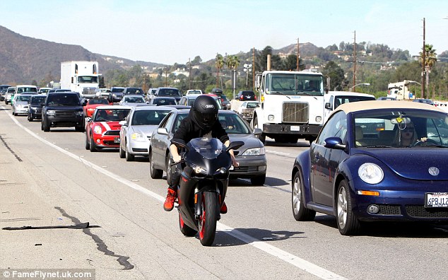 Biker boy: The star received a ticket while driving in his white Ferrari on Tuesday