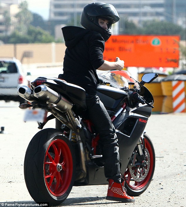 Wheels on fire: Justin Bieber zooms around Beverly Hills on his Ducati motorbike on Wednesday