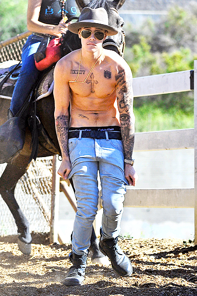 A shirtless Justin Bieber goes horseback riding with his friends in Toluca Lake, CA