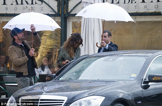 There's About About Madalina: Both Butler and her driver shielded her from the rain