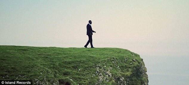 On the edge: Idris Elba teeters near the end of the cliff in the suspenseful video promo