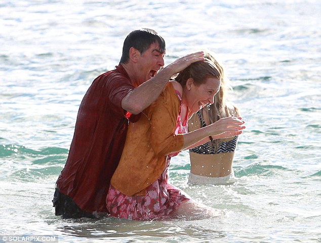 Take that! He threw himself into character as he dunked co-star Toni Collette in the sea while they were both fully clothed