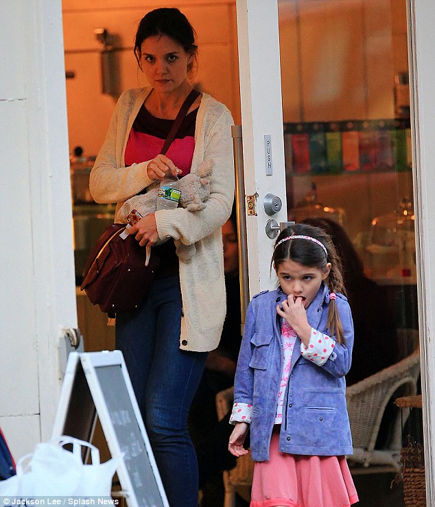 Afternoon outing: Little Suri looked much more stylish in her suede lilac parka, pink skirt, and red flats