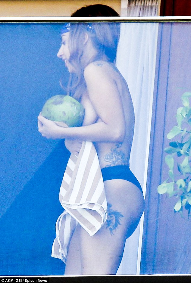 Strategically placed: Gaga's modesty was protected with a strategically placed coconut 
