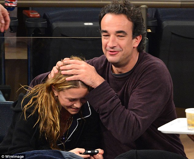 Joking around: Mary-Kate Olsen tries to look at her phone as her boyfriend plays a joke on his young love 
