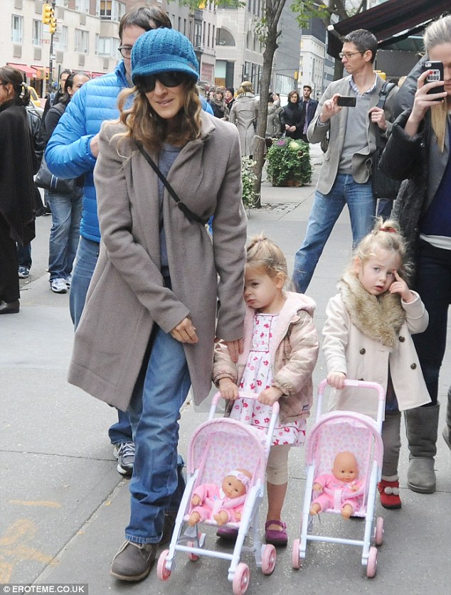 My turn to push: Little Marion and Tabitha push their own baby dolls down the New York street on Friday with husband Matthew Broderick