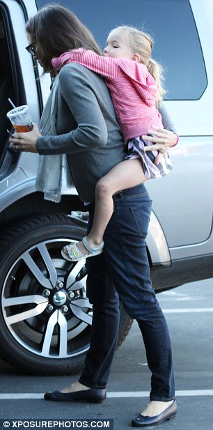 Hitching a ride: The youngster may have been a little tired after the duo's trip to the Brentwood Country Mart