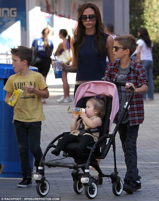 Bonding time: Victoria took charge of the children while husband David was not seen