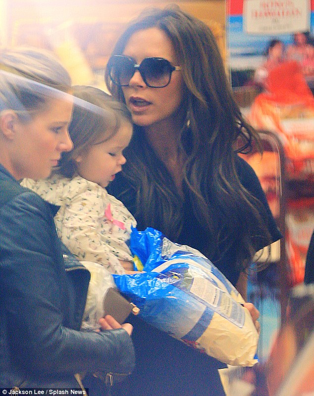Prior to their flight: Victoria and Harper were pictured a grocery store before they arrived at the airport