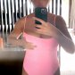 Крисси Тейген пытается подогнать обвисшую грудь, примеряя понравившийся розовый купальник